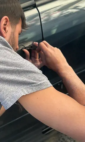 Technician opening a locked car door without damage