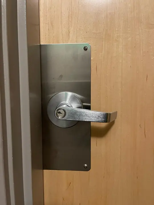 Commercial lever handle and plate on an office door