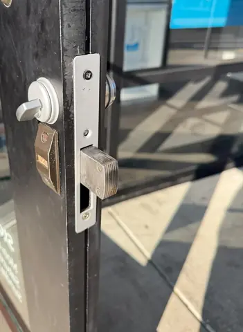Storefront door deadbolt with hook bolt