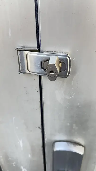 Locking hasp installed on a cabinet
