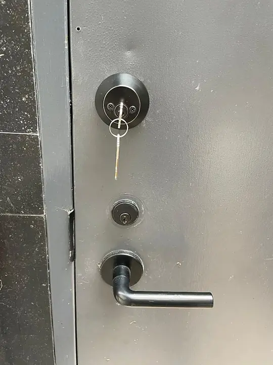 Matte black deadbolt and lever installed